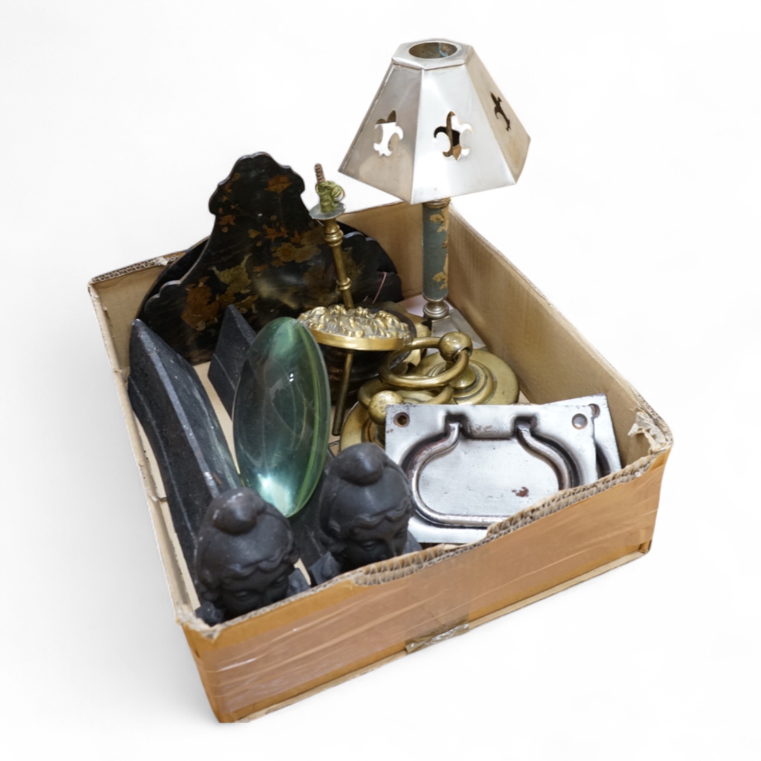 A collection of metalware to include a pair of cast iron firedogs, brass tiebacks and a lamp